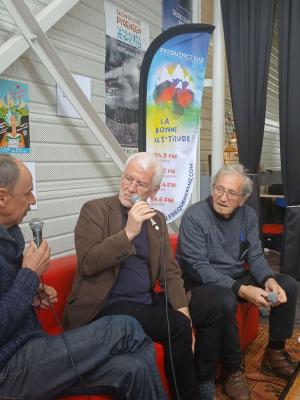 trois personnes assises sur un sofa discutent en tenant des micros
